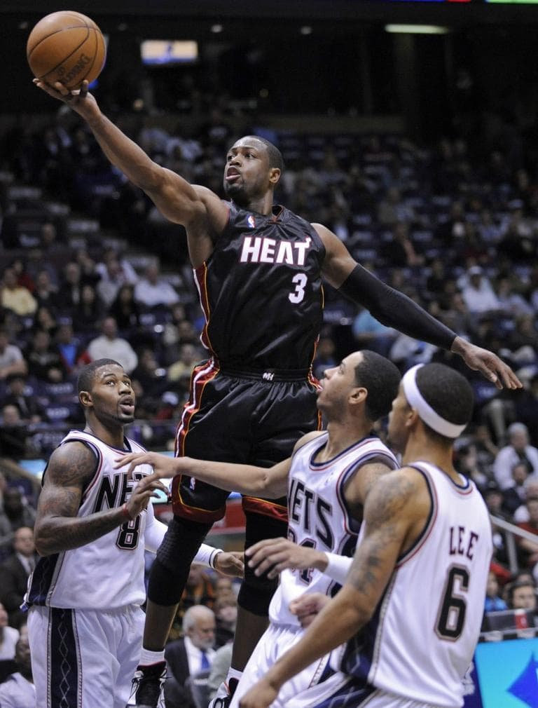 Rising easily over the Nets, the Miami Heat's Dwyane Wade puts up a shot. (AP)