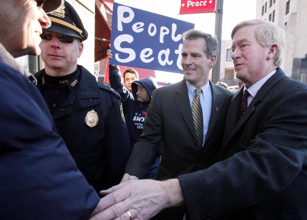 Then-U.S. Senate candidate Scott Brown and former Gov. Bill Weld, right, greet a supporter on the way to a Brown campaign rally Jan. 16 in Quincy. (AP)