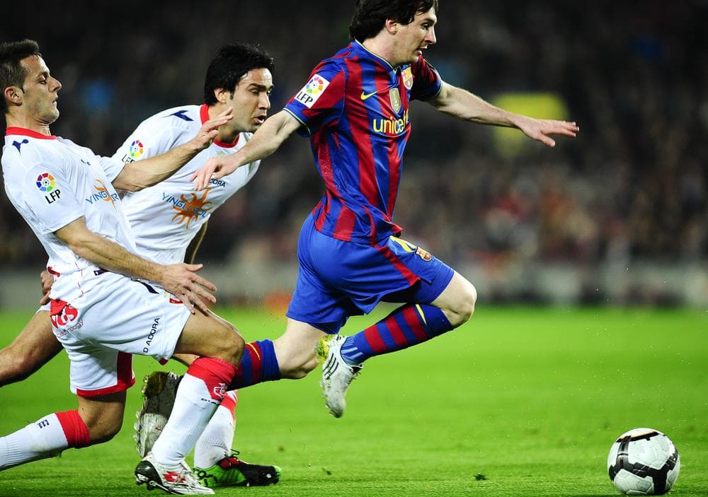 FC Barcelona's Lionel Messi from Argentina (right), duels for the ball in a match against Osasuna FC in Barcalona. (AP Photo)