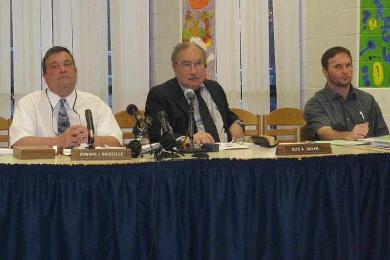 Superintendent of South Hadley Public Schools Gus Sayer, center, and school committee chairman Ed Boiselle, left, at Wednesday night's public meeting in South Hadley. (Deborah Becker/WBUR)