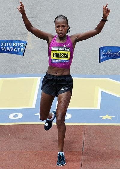 Teyba Erkesso, of Ethiopia, raises her arms as she breaks the finish line tape to win the Boston Marathon women's race on Monday. (AP) (Click to enlarge)