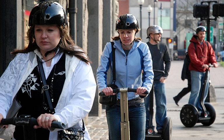 Riders take a recent Segway tour past Boston's Faneuil Hall. (Sonari Glinton for WBUR)
