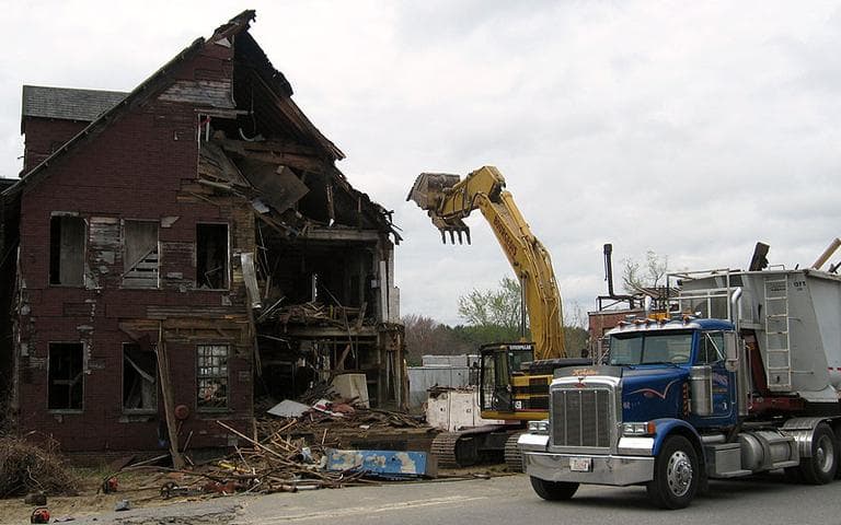A wrecking crew demolishes the S. Bent &amp; Brothers, Inc., chair-making complex in Gardner. (David Boeri/WBUR)