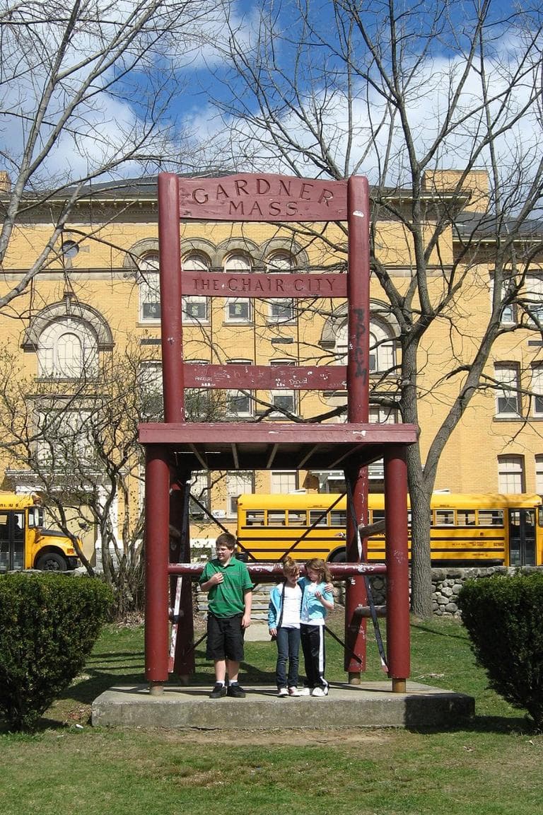 Children gather round 'Chair City's landmark. (David Boeri/WBUR)