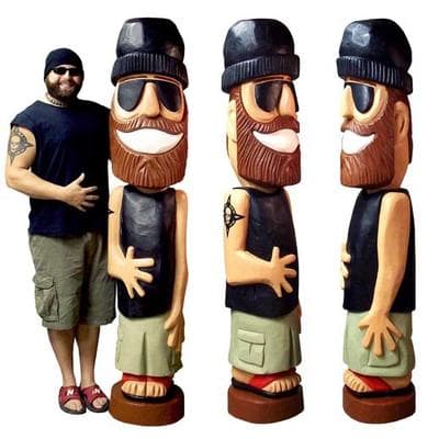 Jesse Green poses with the statue he carved of himself. (Courtesy Jesse Green)