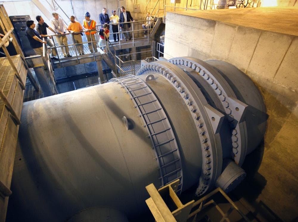 Massachusetts Gov. Deval Patrick, top fourth from left, visits a tunnel at the site of a major water main break in Weston on Sunday. The pipe in the foreground contains a shutoff valve and feeds into the pipe that failed. (AP)