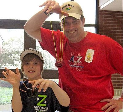 Shane O’Donnell, 10, and his dad, James, yo-yo together at the regionals. (Bill Littlefield/WBUR)