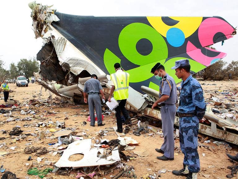 Rescue teams search the site of the Libyan Afriqiyah Airways plane crash in Tripoli, Libya, on Wednesday. (AP)