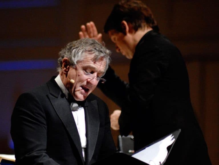 Actor Robert De Niro, foreground, reads while the Pops' Keith Lockhart conducts during Tuesday's "The Dream Lives On" premiere. (Michael J. Lutch) (Click to enlarge)