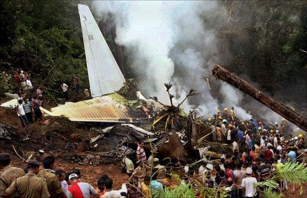 Indian firefighters and rescue personnel try to extinguish the flames around the site of an Air India plane that crashed in Mangalore, as it overshot a precarious hilltop runway in southern India while trying to land in the rain. (AP)