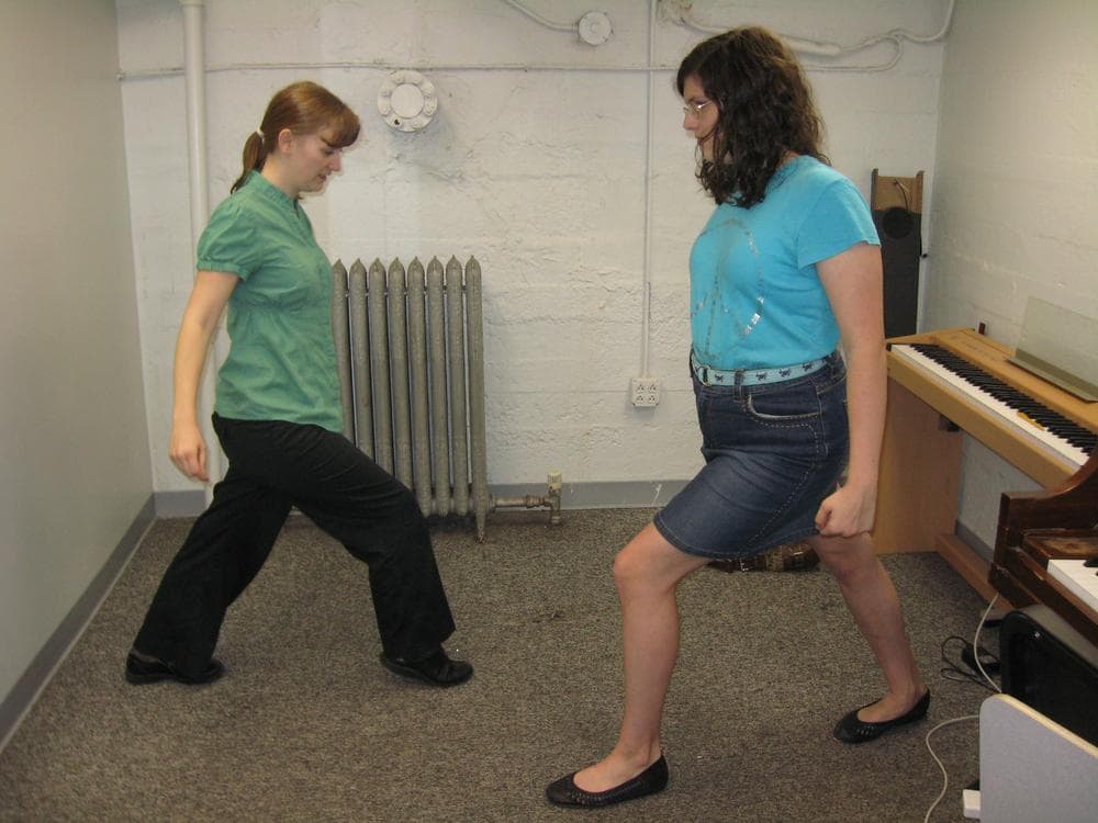 Before her Boston Conservatory voice lesson, Gianna Hitsos (right), 14, does stretches and warm-ups with her instructor, Sara Cathell-Williams. (Sacha Pfeiffer/WBUR)