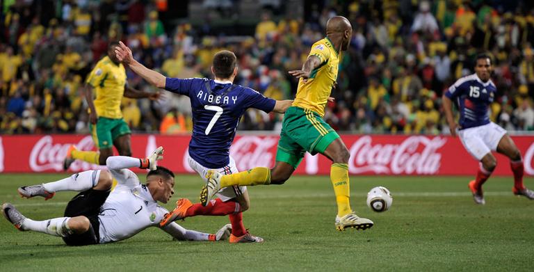 France's Franck Ribery, center, crosses the ball to Florent Malouda, right, to score a goal during a match against South Africa on Tuesday. France lost though, 2-1, and was ousted from the World Cup. (AP)