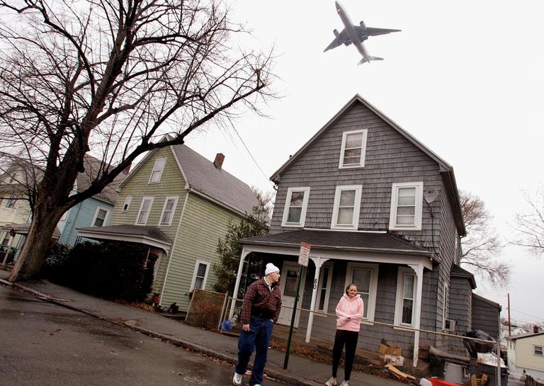 Mary Nunziato, right, stands in front of her foreclosed home in Revere. A program from Boston Community Capital seeks to help foreclosed owners keep their homes. (AP)