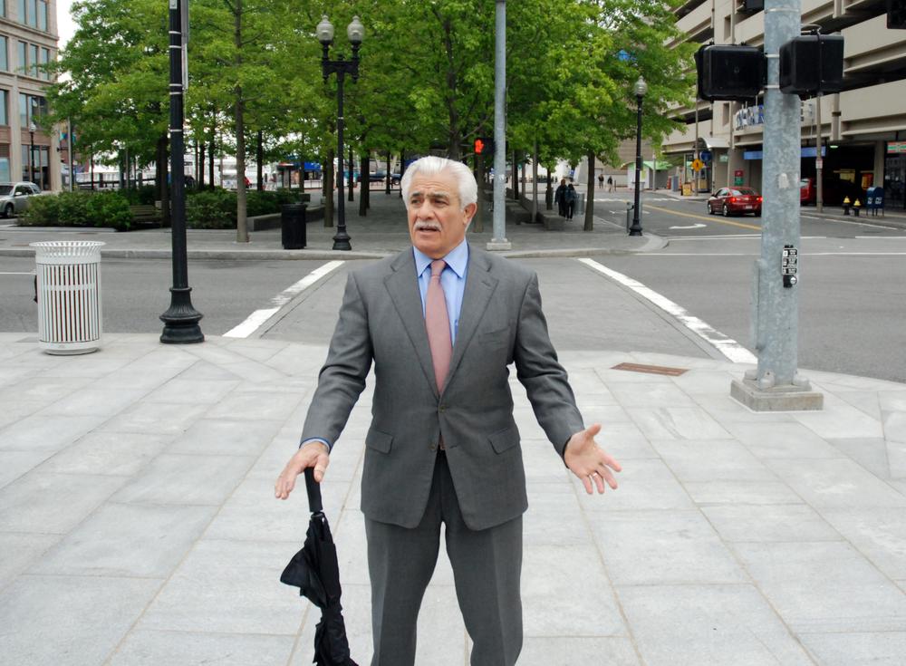 Developer Don Chiofaro stands on the Greenway near the Harbor Garage, a structure he hopes to tear down and erect two tall towers in its place. (Lisa Tobin/WBUR)