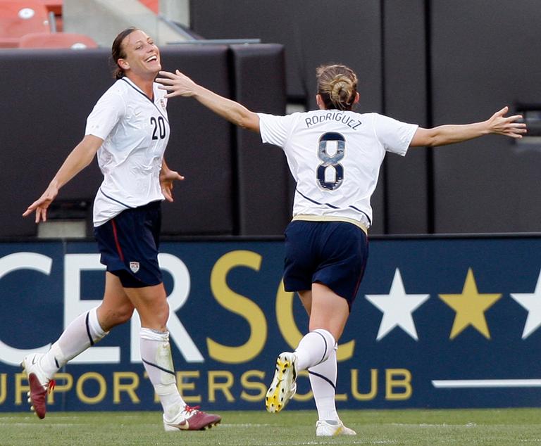 Abby Wambach (20) celebrates a U.S. Soccer goal with teammate Amy Rodriguez in a match in May. Wambach chose her "side" in the WPS All-Star Game. (AP)