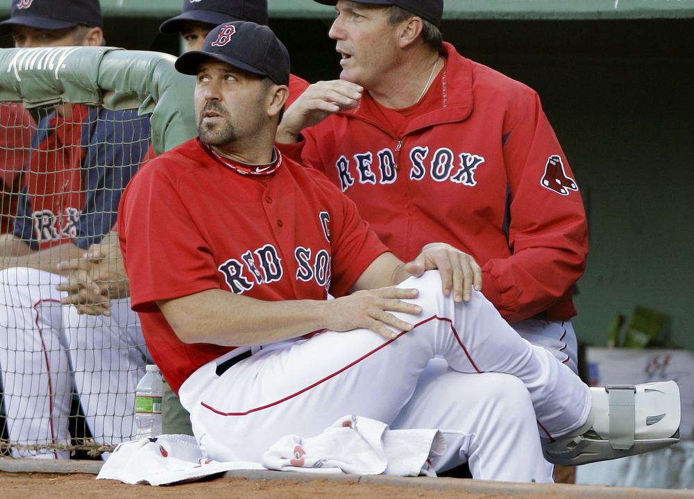 With his right foot in a cast,  Red Sox catcher Jason Varitek watches the first inning against the Orioles at Fenway Park , Friday.(AP Photo/Charles Krupa)