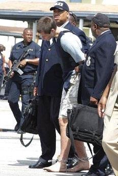 Colton Harris-Moore arrives barefoot, handcuffed and shackled as he is escorted by police to Nassau, Bahamas, July 11, 2010. (Credit: flickr/underthelaw)