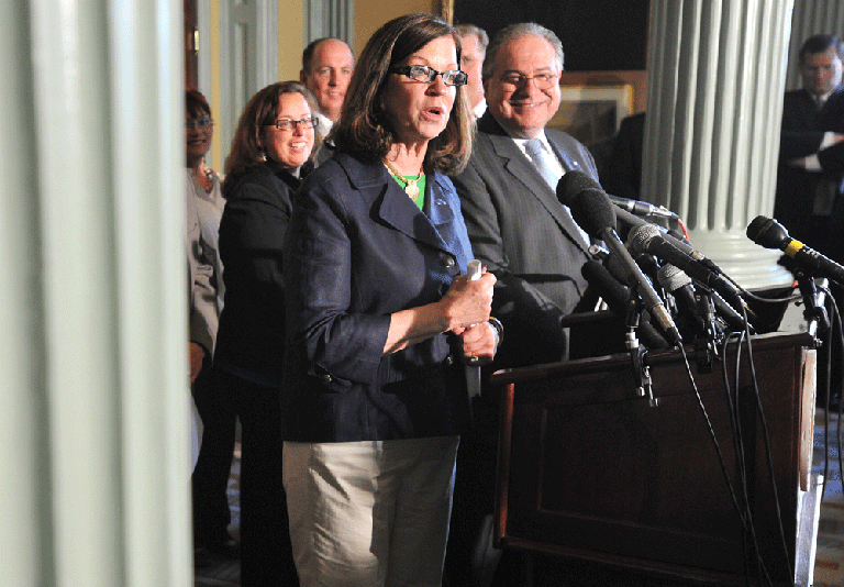 Senate President Therese Murray speaks as Speaker Robert DeLeo looks on at a State House news conference on Friday as legislative leaders announced a bill approving the licensing of three casinos and two slot parlors. (AP)