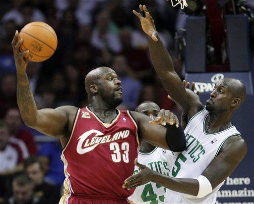 Former Cleveland Cavaliers' player Shaquille O'Neal (33) tries to pass around Boston Celtics' Kevin Garnett during an NBA basketball game in Cleveland in 2009. The Boston Celtics this week signed former rival Shaquille O'Neal. (AP)