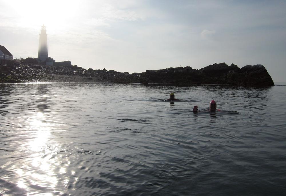 Greg O’Connor, left, and Elaine Howley set a new record for the 16-mile swim from South Boston to the Boston Light and back. (David Boeri/WBUR)