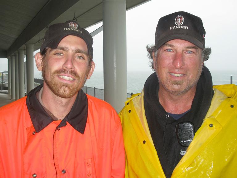 Rangers Peter Duran, left, and Phil Rahaim on Spectacle Island. Rahaim runs a fishing program that depends on private funding. (Fred Thys/WBUR)