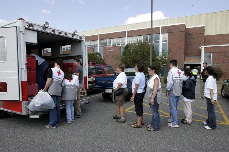 People unload supplies from a Red Cross truck at Massachusetts' Camp Edwards on Sept. 6, 2005 for about 2,500 refugees of Hurricane Katrina. (AP)