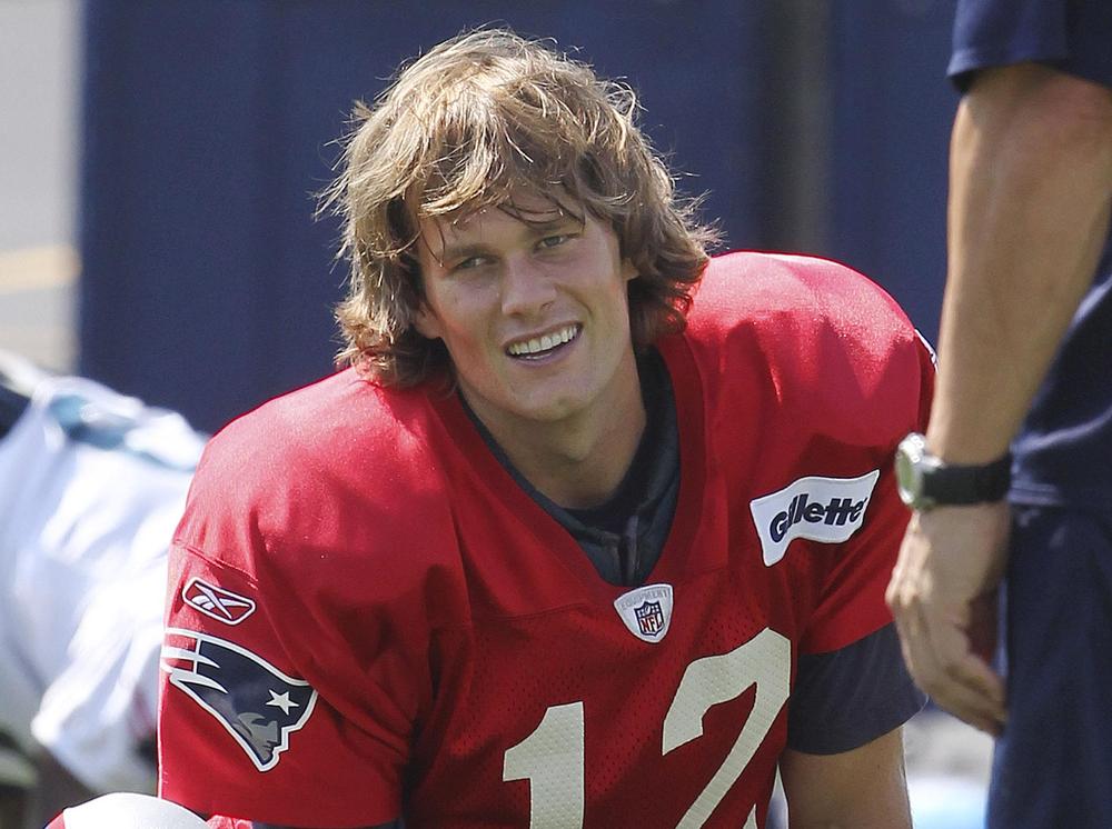 In this file photo, New England Patriots quarterback Tom Brady (12) stretches before NFL football practice at the team's training facility in Foxborough, Mass. (AP)