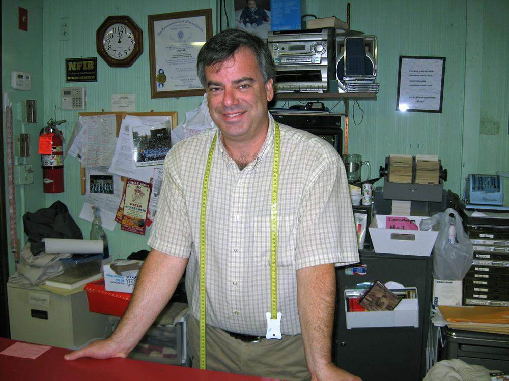 Charlie Lask owns the men's clothing store Nat Falk, on Main Street, which has stayed open for 74 years. He also impersonates Neil Diamond. (Lisa Tobin/WBUR)