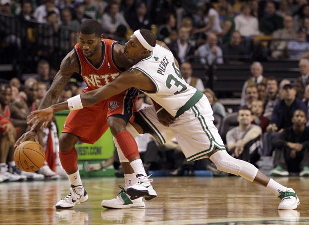 Boston's Paul Pierce (34) reaches in to try to steal the ball from New Jersey's Terrence Williams during the first half of a preseason game in Boston on Wednesday. (AP)