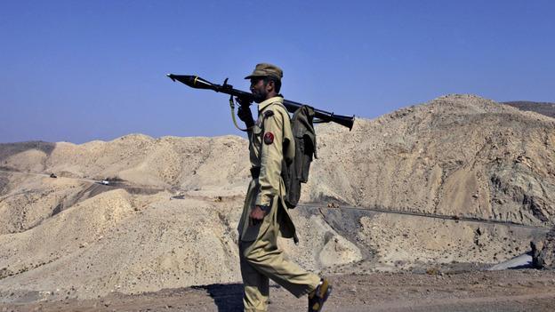 A Pakistani paramilitary soldier patrols a hill in the Waziristan tribal region along the Afghan border. (AP)