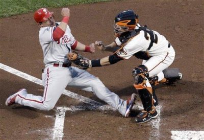 Giants catcher Buster Posey tags out Phillies' Carlos Ruiz during Game 4 of the National League Championship Series. (AP Photo/David J. Phillip)