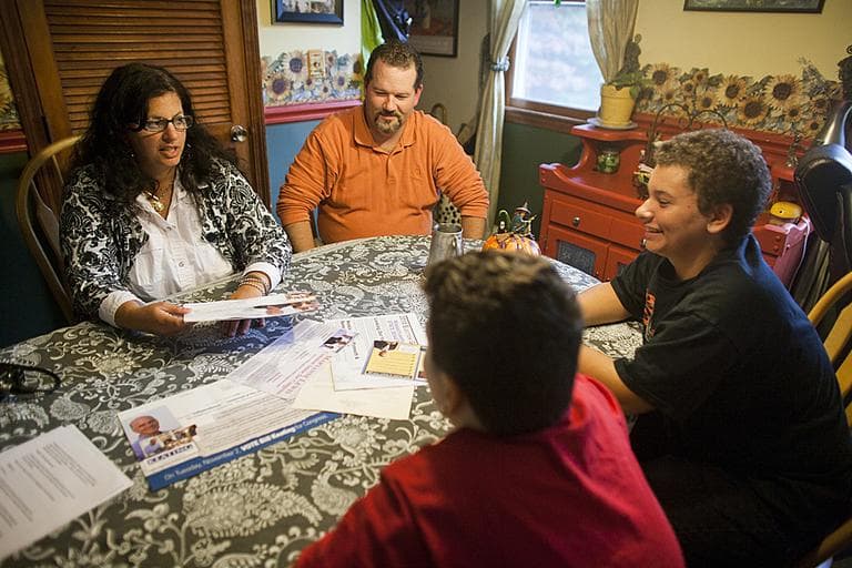 The Betz family, from left: Debra, Stephen, Stewart, and Spencer chat with WBUR's Bob Oakes around their kitchen table. (Dominick Reuter for WBUR) 
