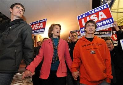 At center, United States Senator Lisa Murkowski (R) Alaska walks to Anchorage, Alaska's election central with sons Nick, left and Matt. (AP)