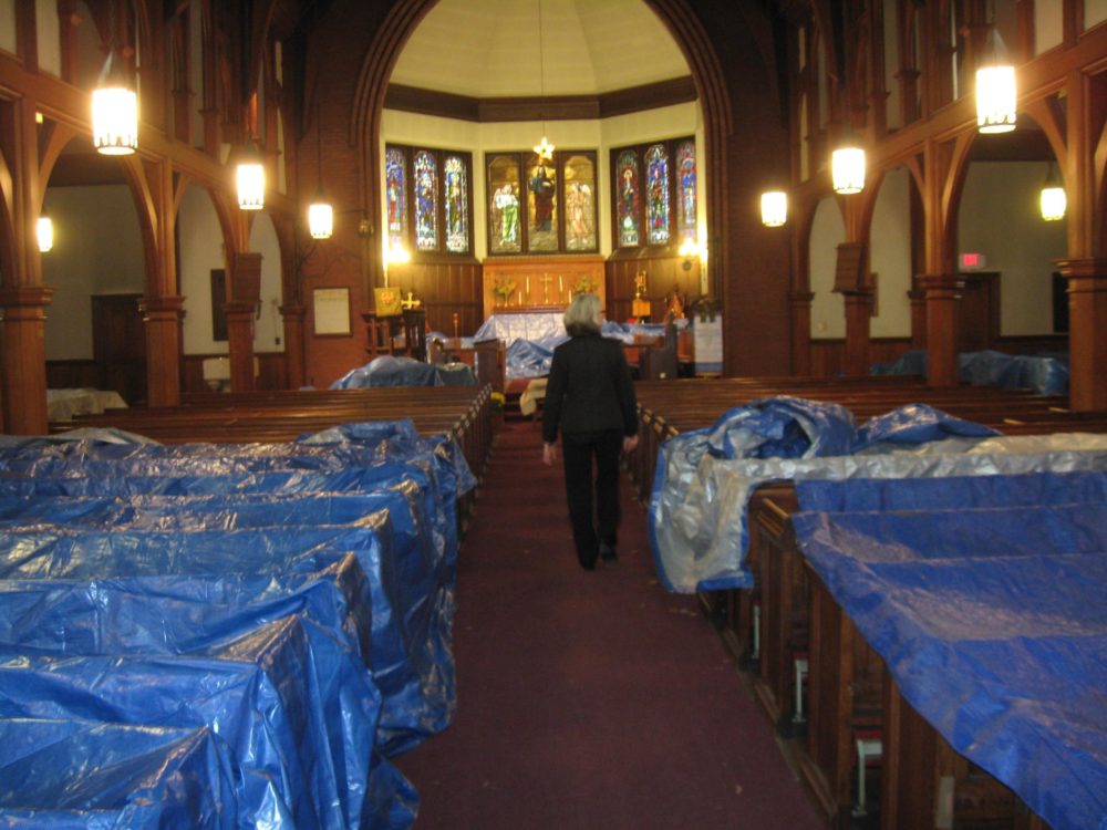 Rev. Cathy George inside St. Mary’s Episcopal Church as it undergoes a renovation. (Adam Ragusea/WBUR)