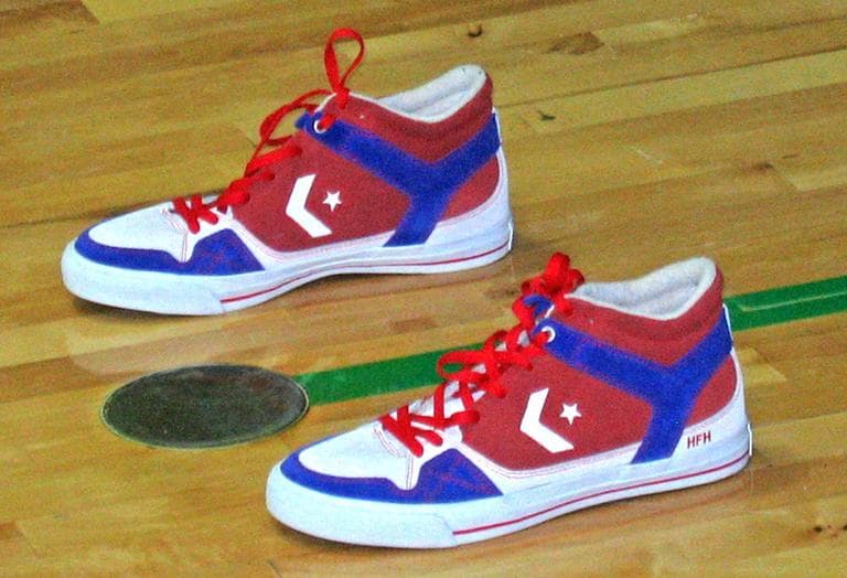 During each free throw shooting session, Dave Cummings places this pair of sneakers out of bounds behind the basket. Cummings says they remind him of the members of the military who are away from their homes and families. (Doug Tribou/WBUR)