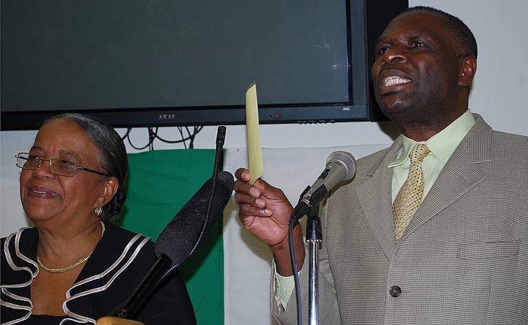 Haiti presidential candidate Mirlande Manigat, left, spoke in October at the Sant Belvi Senior Center in Mattapan. Oswald Neptune is the center's director. (Bianca Vazquez Toness/WBUR)