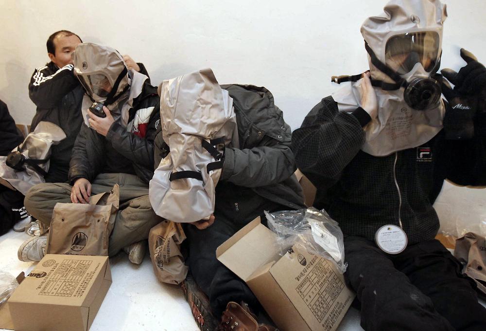 South Korean residents wear their gas masks at a shelter on Yeonpyeong island, South Korea. (AP)