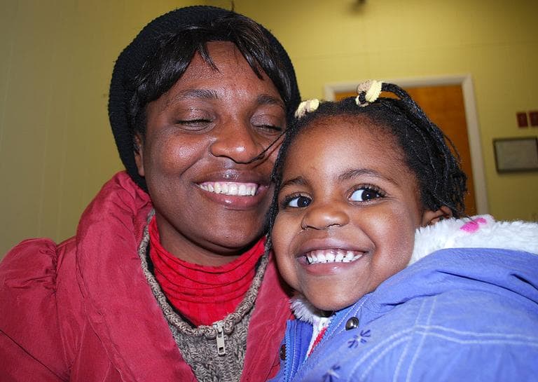 A year after the quake, Florence picks up her daughter at daycare. (Bianca Vazquez Toness/WBUR)