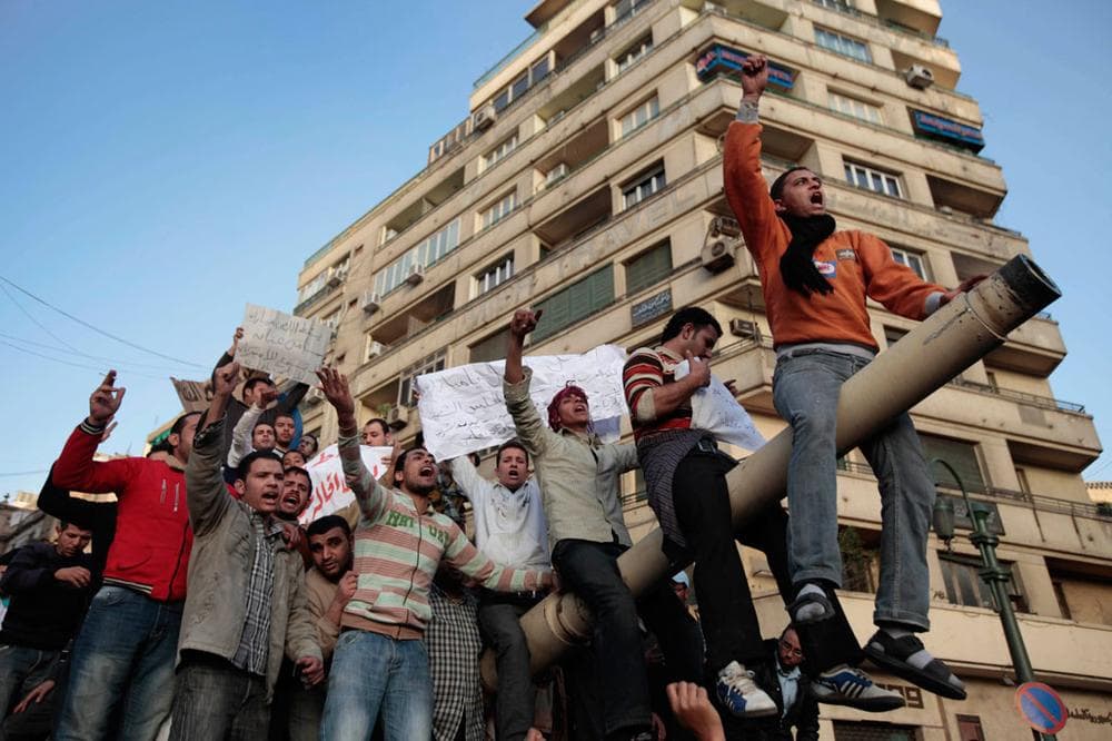 Egyptian anti-government protesters chant slogans as they stand atop an Egyptian army tank during a protest in Tahrir Square in Cairo, Egypt, Saturday.