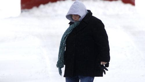A woman walks on a wintry road in Philadelphia. (AP)