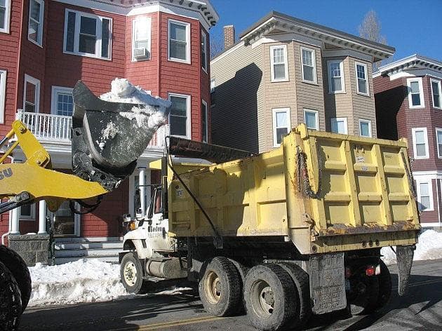 Trucks moved snow off the streets and to "snow farms" in South Boston Wednesday. (Monica Brady-Myerov/WBUR)