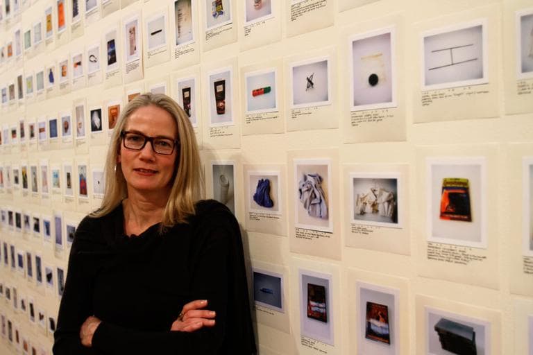 Artist Rachel Perry Welty with the 1,952 items she's photographed — and trashed. (Andrea Shea/WBUR)
