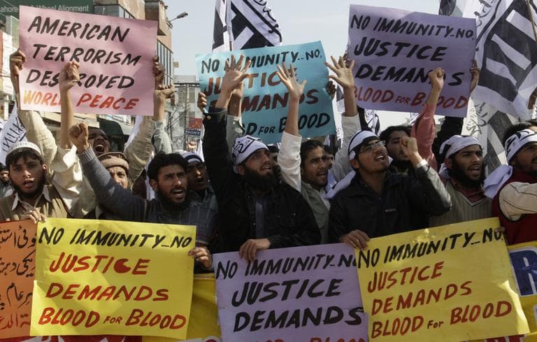 Protestors rally to condemn a shooting incident involving Raymond Davis. (AP)
