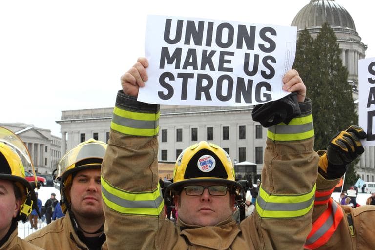 Firefigher Brian Ritter of Ocean Shores, Wash., holds a pro-union sign during a rally supporting Wisconsin public sector unions on the Capitol campus in Olympia, Wash. (AP)