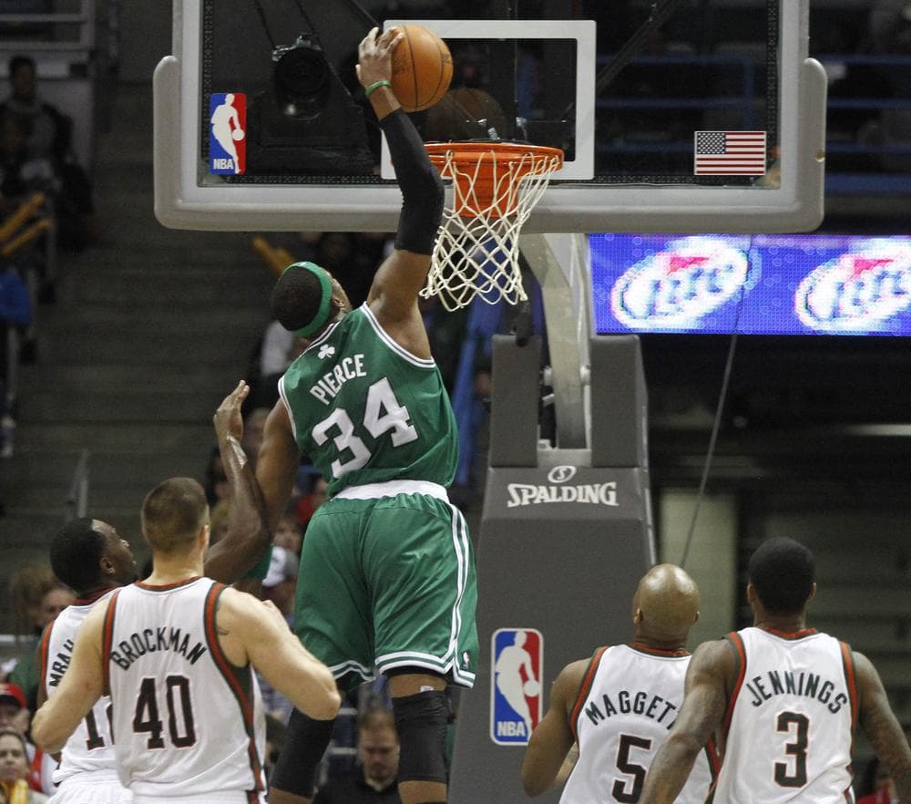 Boston Celtics' Paul Pierce, center, goes up for a dunk against the Milwaukee Bucks in the second half of the game Sunday in Milwaukee. (AP)