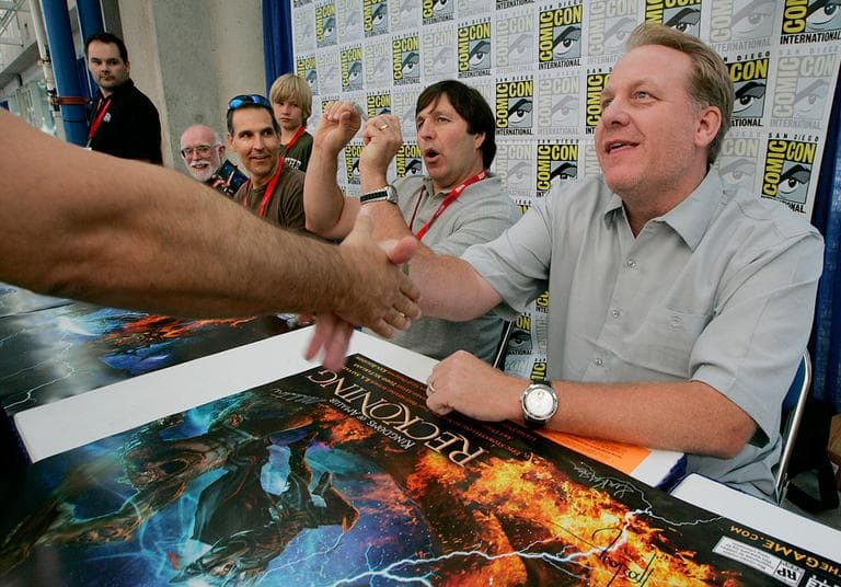 At right, former Red Sox pitcher Curt Schilling shakes hands with a fan at Comic-Con in July 2010 in San Diego. Schilling's 38 Studios will demo “Kingdoms of Amalur: Reckoning” at this weekend's PAX East in Boston. (AP/Electronic Arts)