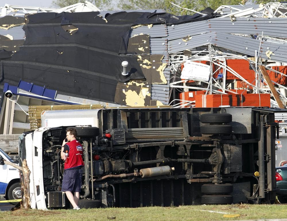 Lowes Home Improvement employee stands in the parking lot of there store after it was hit by a tornado in Sanford, N.C. (AP)