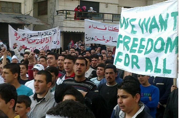 In this captured on a mobile phone, Syrian anti-government protesters march during a demonstration in Banias, Syria, Sunday. (AP)