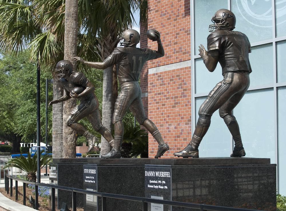 The statues of former Florida quarterbacks and Heisman Trophy winners, from left, Tim Tebow, Steve Spurrier and Danny Wuerffel are displayed outside of Ben Hill Griffin Stadium. (AP)