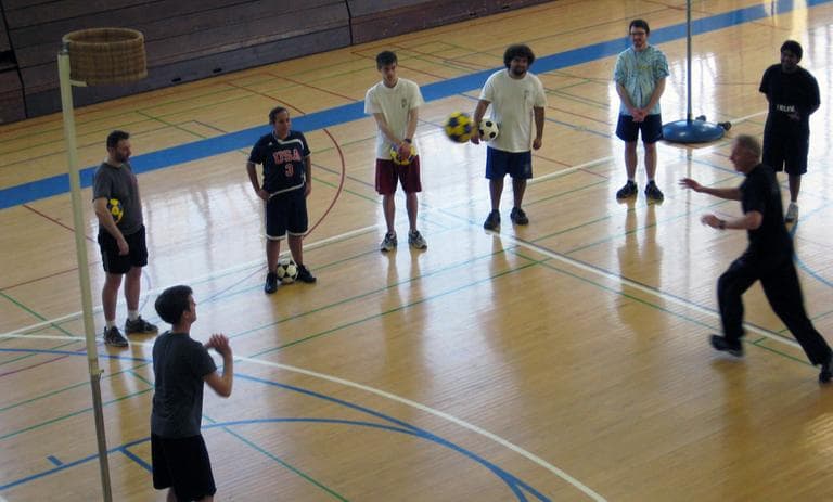 Barker teaches students how to pass the korfball (Doug Tribou/WBUR)